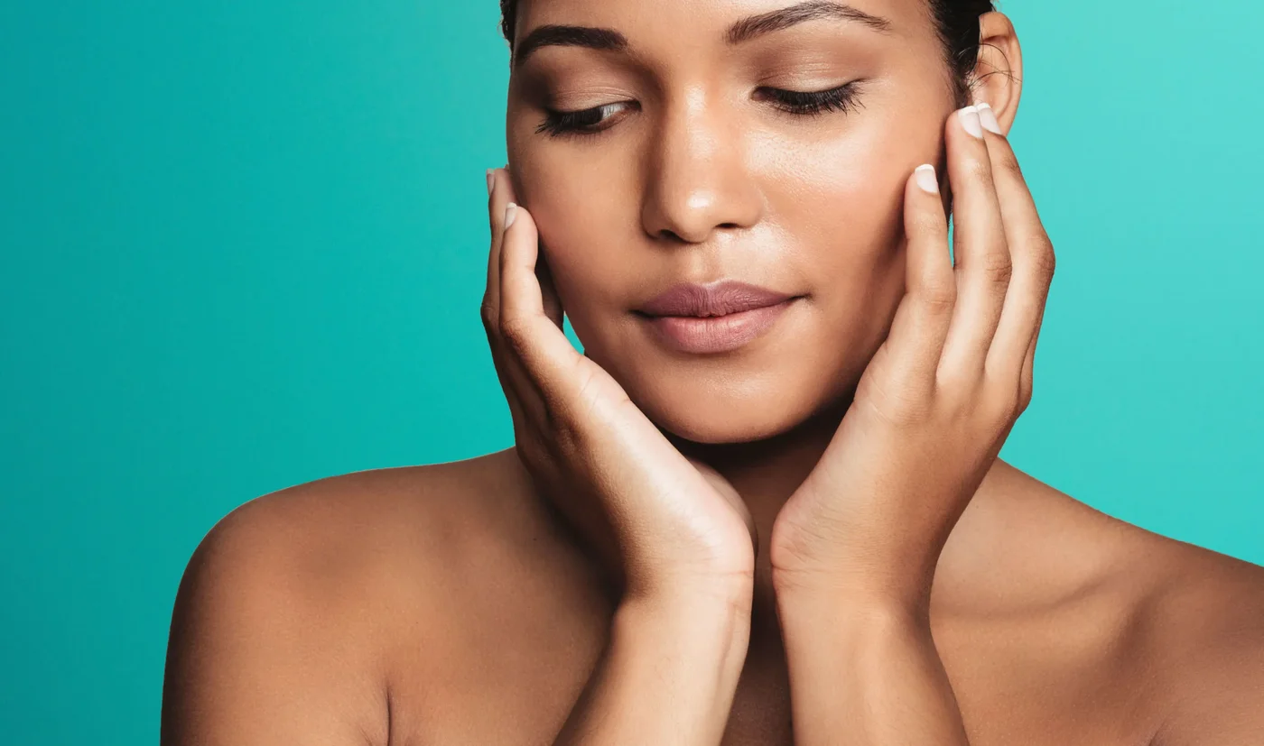 Close-up of a woman with eyes closed framing her face with both hands for Morpheus8 skin remodelling in London Close-up of a woman with eyes closed framing her face with both hands for Morpheus8 skin remodelling in London